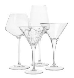 Photo of Different elegant empty glasses isolated on white