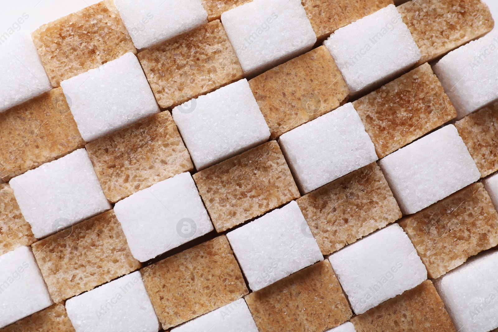 Photo of White and brown sugar cubes as background, top view