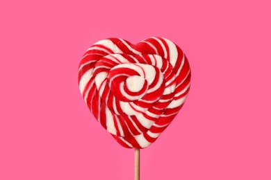 Sweet heart shaped lollipop on pink background, closeup. Valentine's day celebration