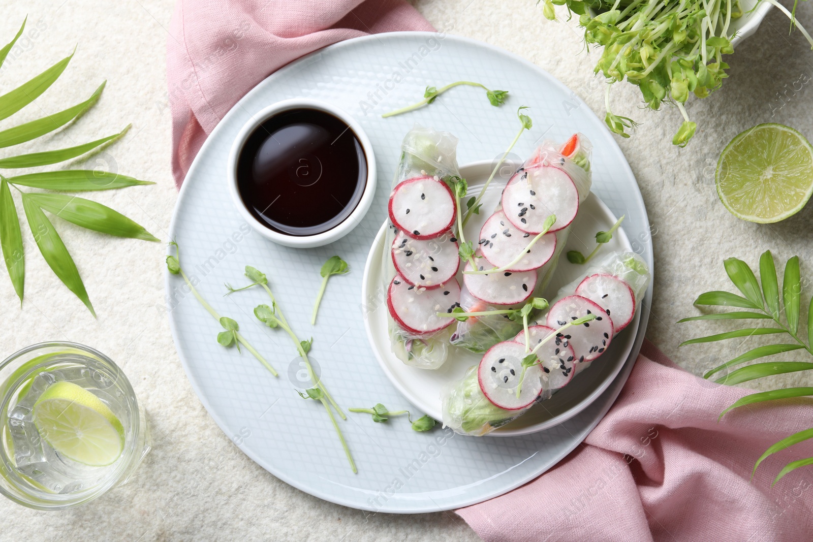 Photo of Delicious spring rolls served on light grey table, flat lay