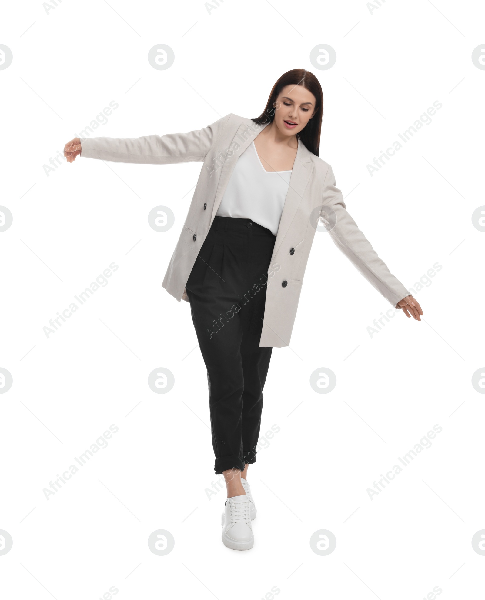 Photo of Beautiful businesswoman in suit walking on white background