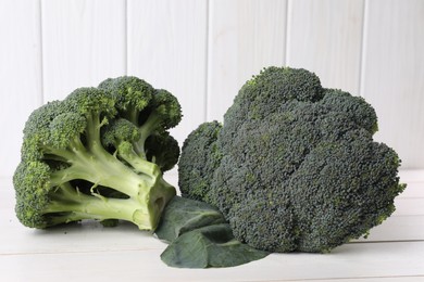 Fresh raw broccoli on white wooden table, closeup