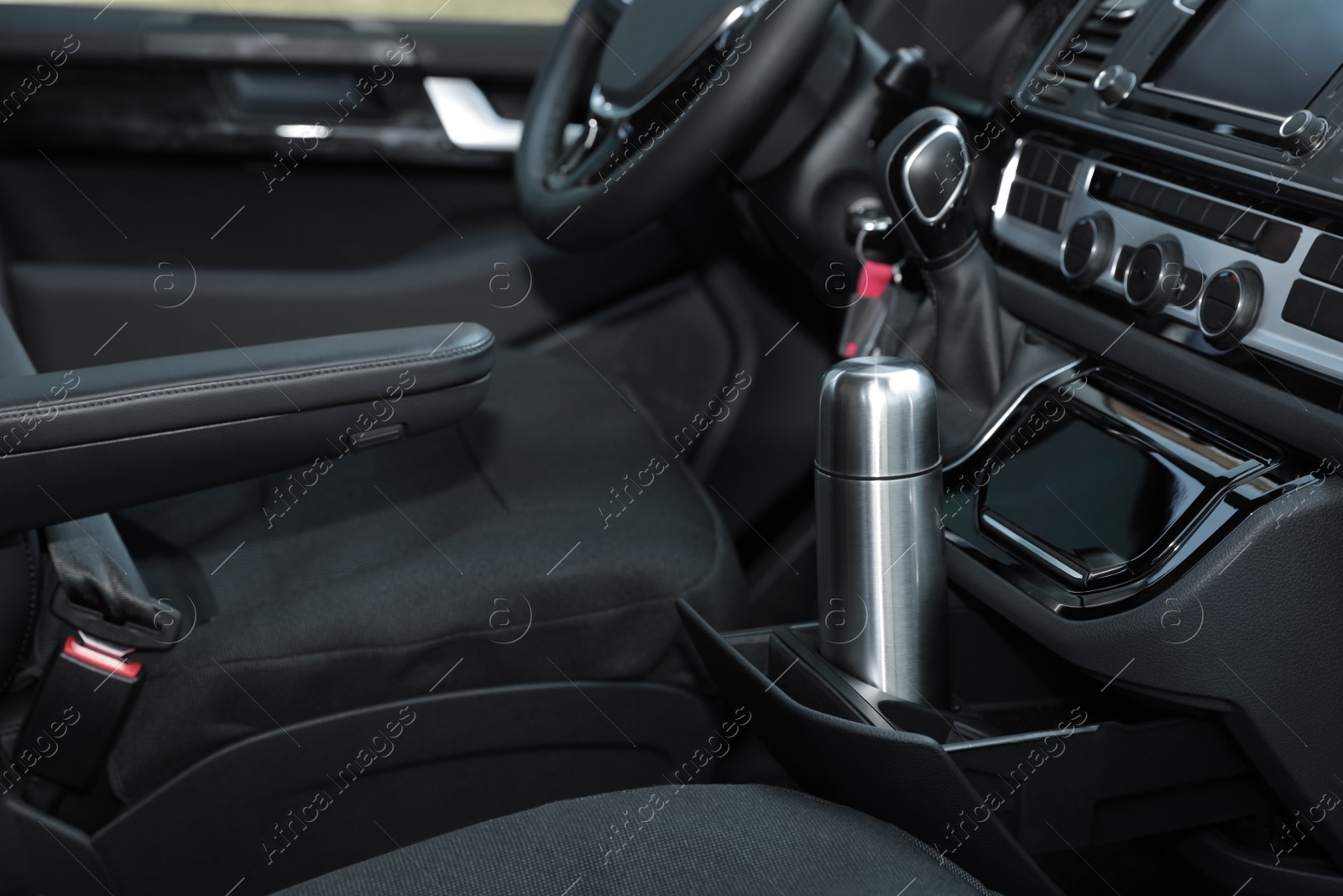 Photo of Silver thermos in holder inside of car