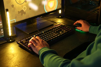 Man playing video games on computer indoors, closeup