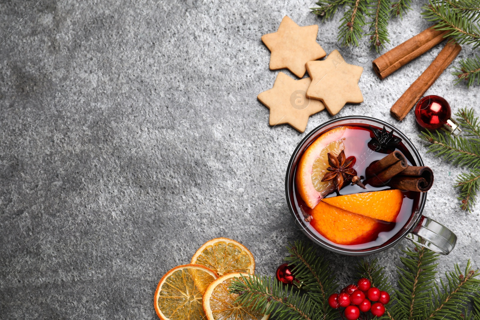 Photo of Flat lay composition with aromatic mulled wine on grey table. Space for text