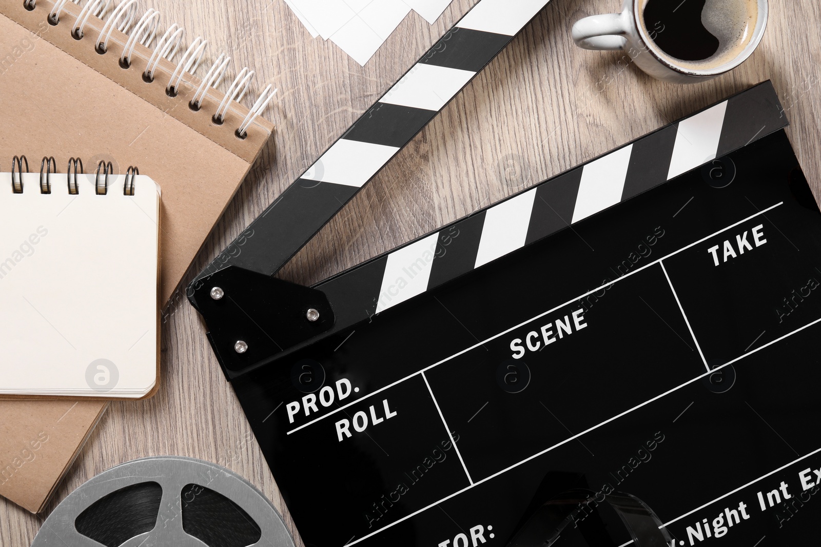 Photo of Flat lay composition with movie clapper on wooden table
