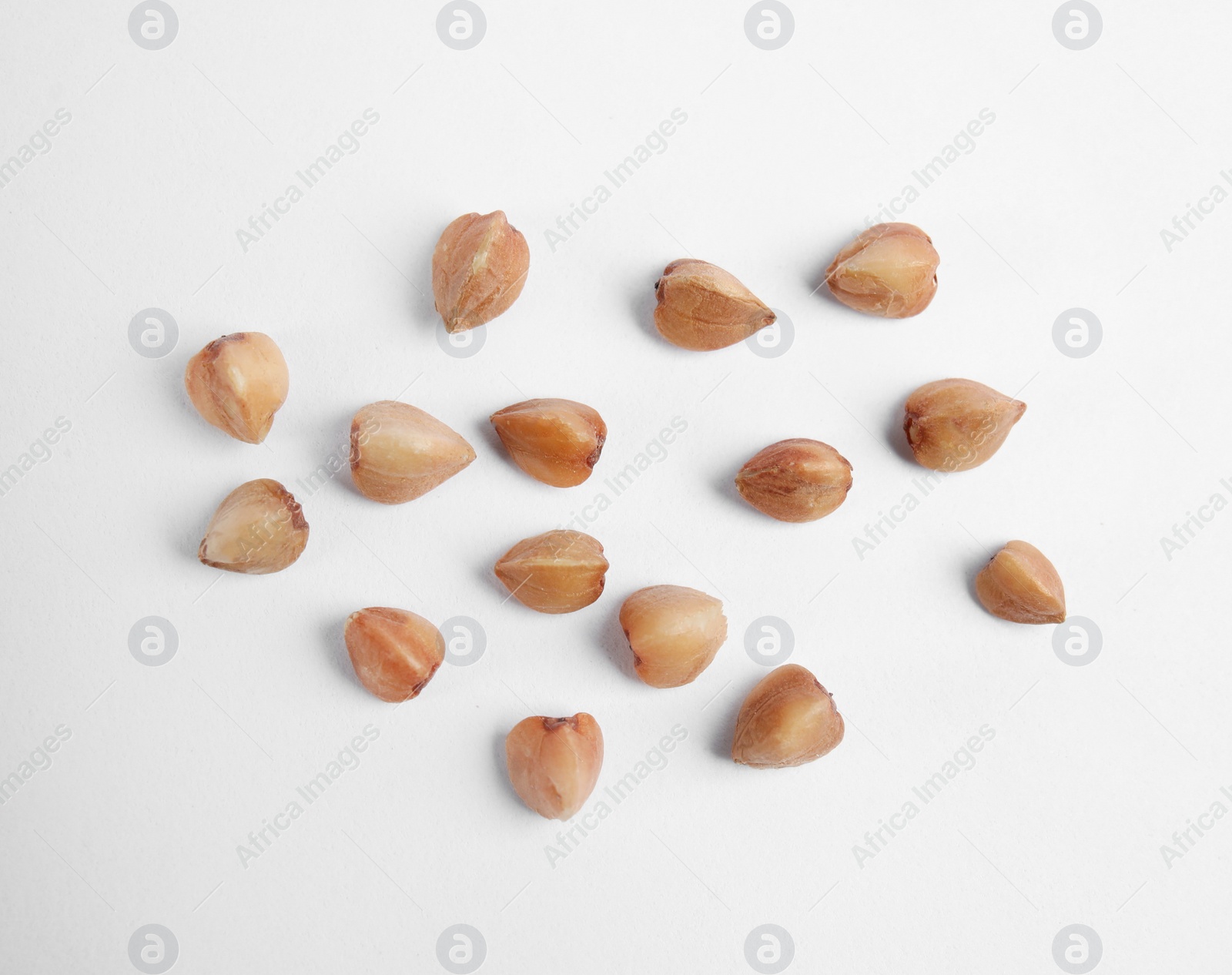 Photo of Uncooked buckwheat on white background, top view