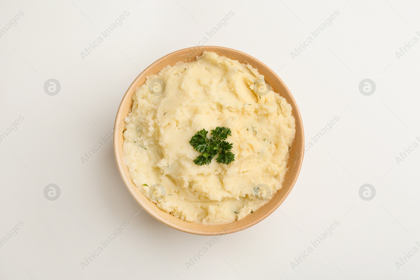 Photo of Bowl with tasty mashed potato on white background, top view