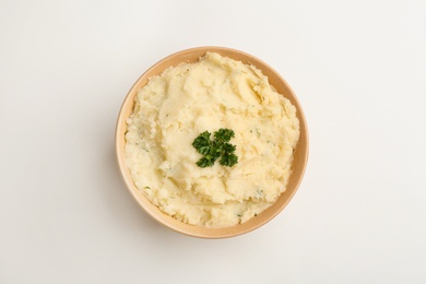 Bowl with tasty mashed potato on white background, top view