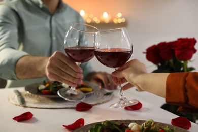 Couple having romantic dinner at home, closeup