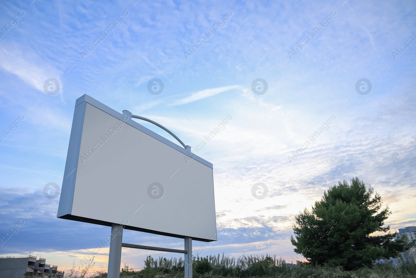Photo of Blank billboard on street, low angle view. Mockup for design
