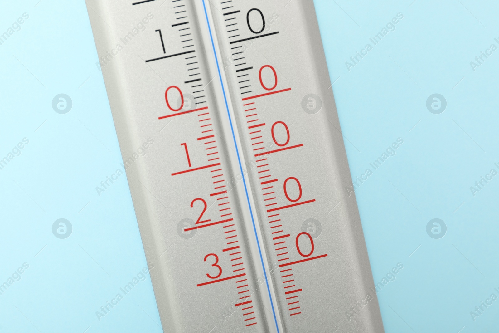 Photo of Weather thermometer on light blue background, closeup
