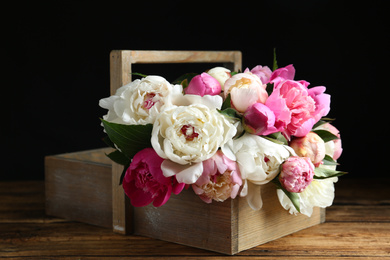 Photo of Bouquet of beautiful peonies on wooden table
