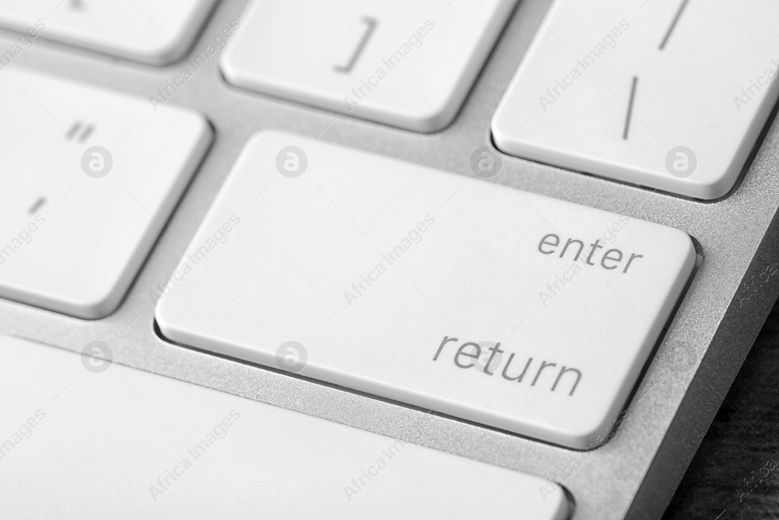 Photo of Modern computer keyboard with white buttons, closeup view