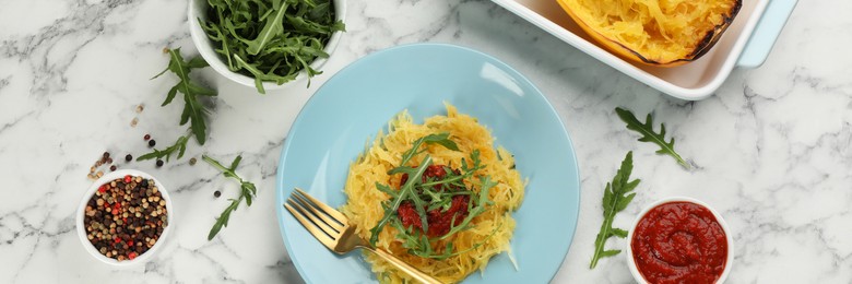 Image of Tasty spaghetti squash with arugula and tomato served on white marble table, flat lay. Banner design