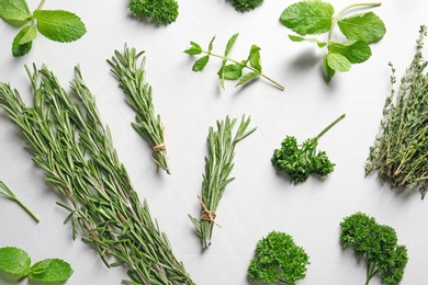 Photo of Flat lay composition with rosemary on light background. Aromatic herbs