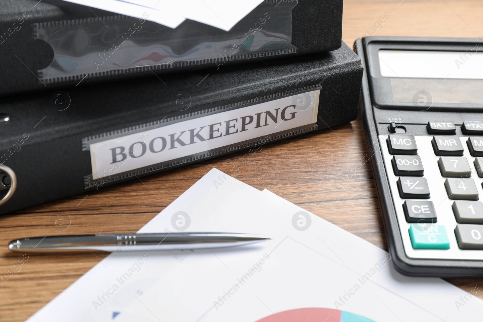 Photo of Bookkeeper's workplace with folders and documents on table