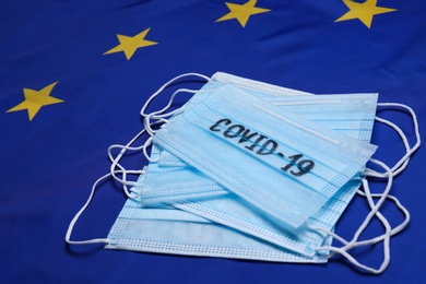 Medical masks with word COVID-19 on flag of European Union