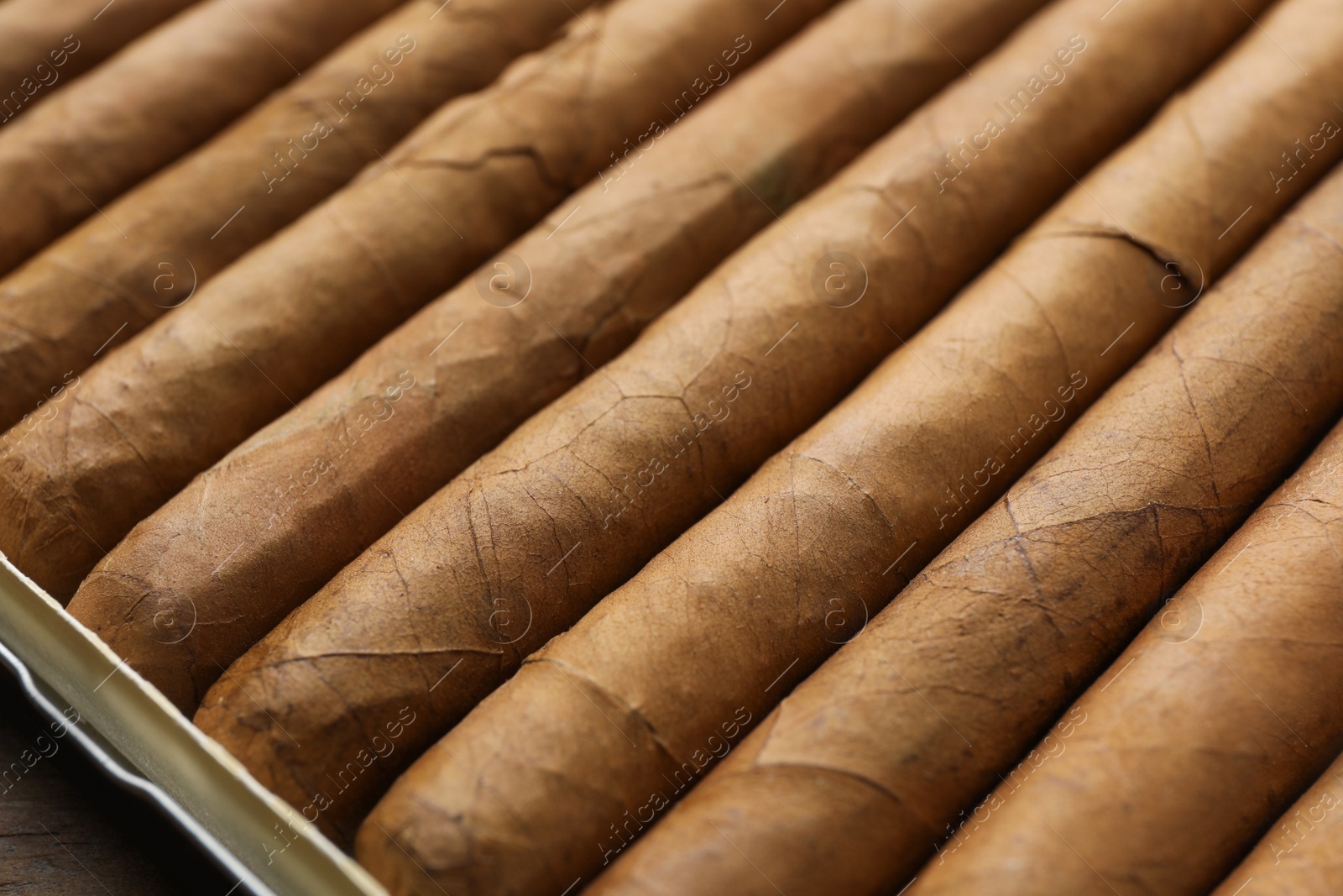 Photo of Many expensive cigars in box on table, closeup