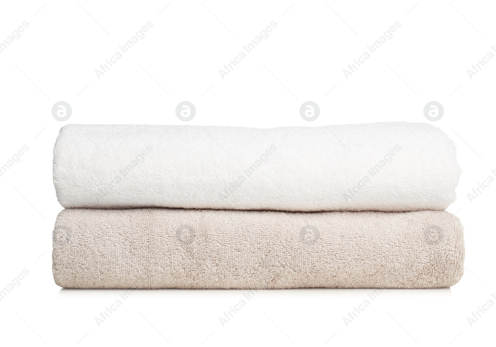 Photo of Folded soft terry towels on white background