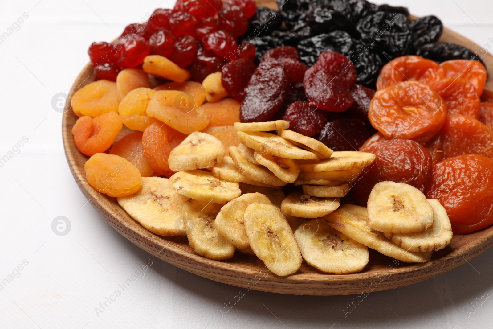 Photo of Delicious dried fruits on white table, closeup