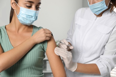 Doctor giving injection to patient in hospital, closeup. Vaccination day