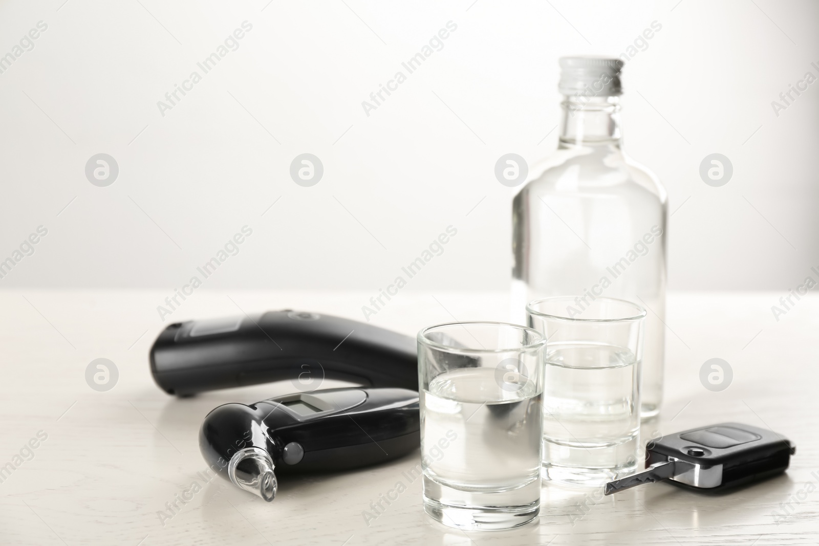 Photo of Composition with modern breathalyzers on white wooden table