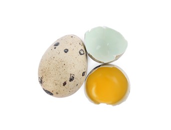 Whole and cracked quail eggs on white background, top view