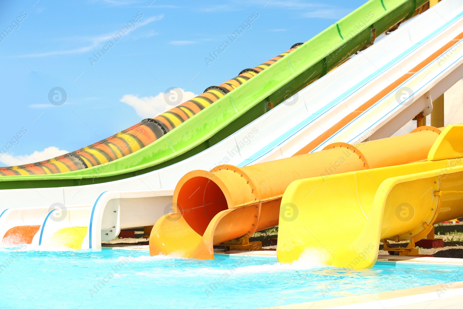 Photo of Different colorful slides in water park on sunny day