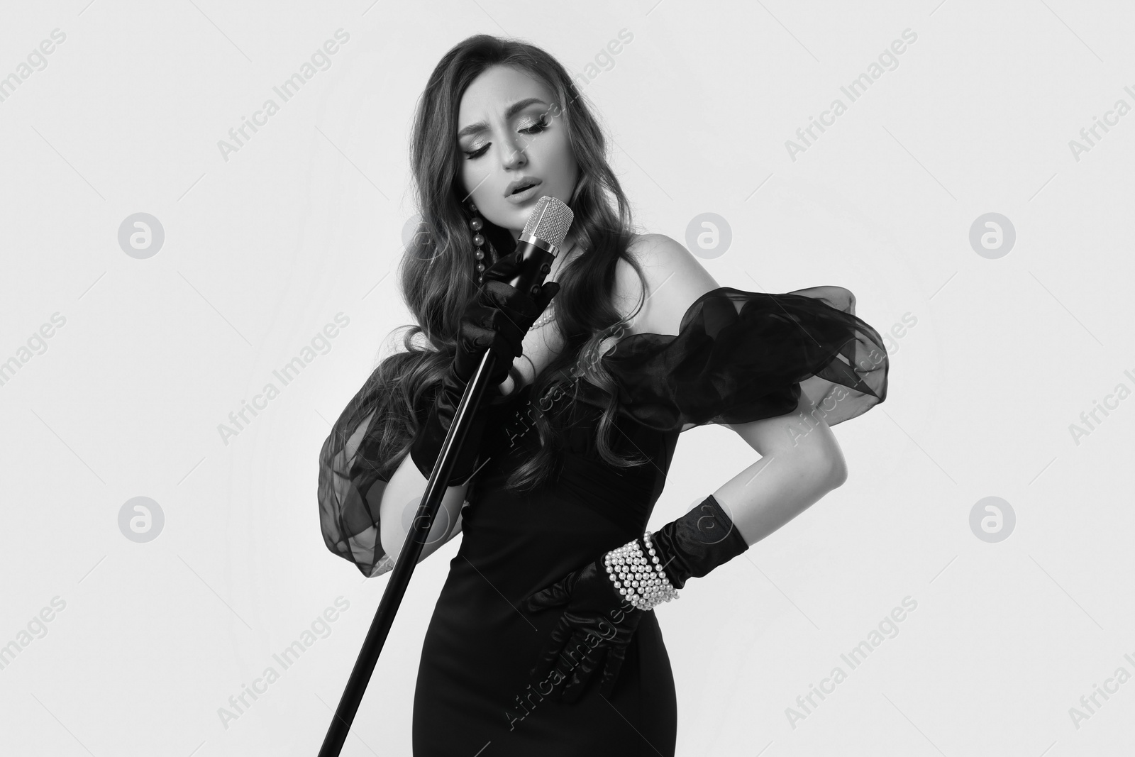 Image of Beautiful singer with microphone, black and white effect