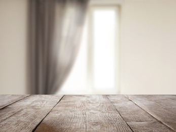 Image of Empty wooden surface and blurred view of modern window 