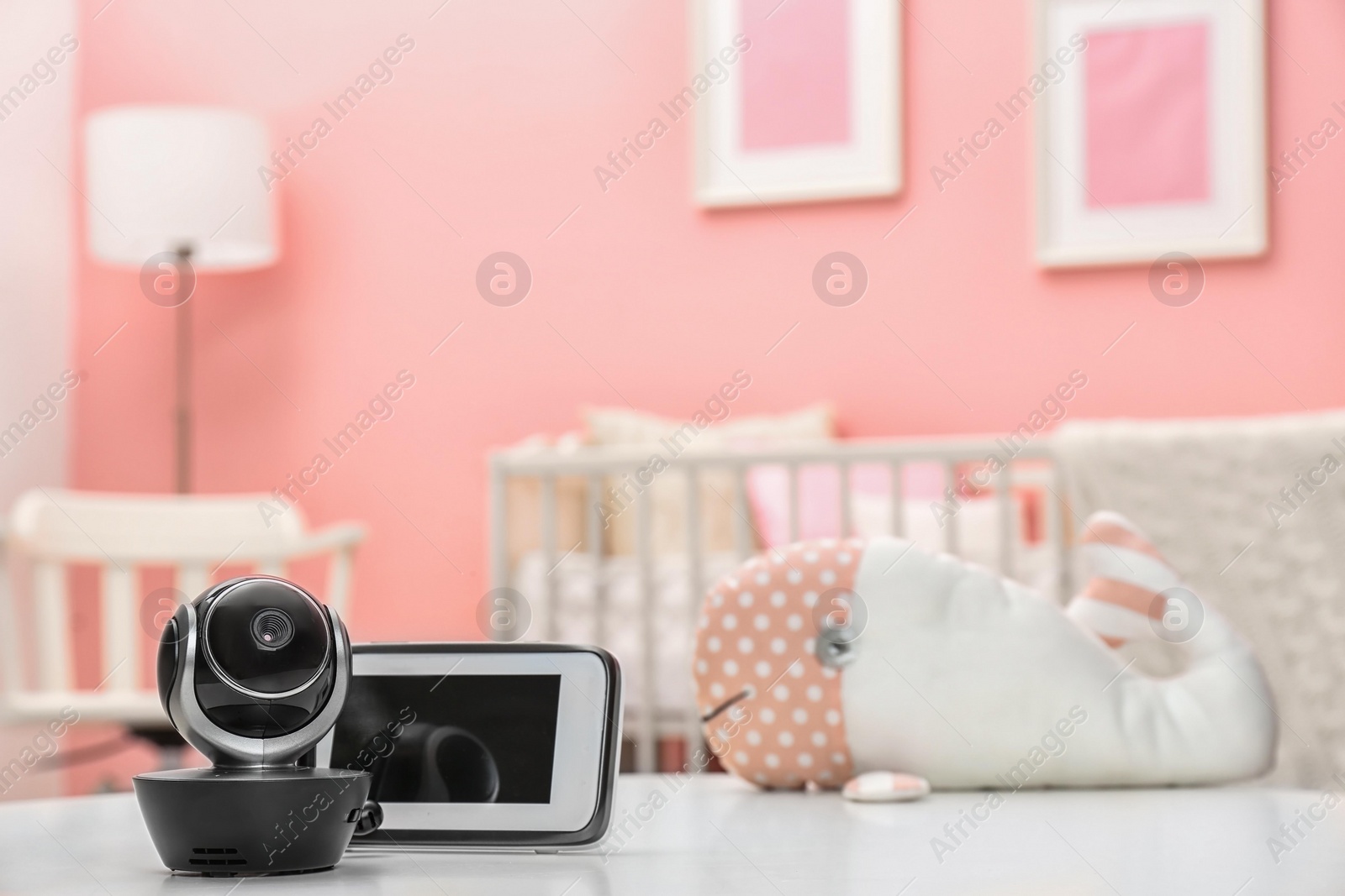 Photo of Baby monitors on table in room, space for text. CCTV equipment