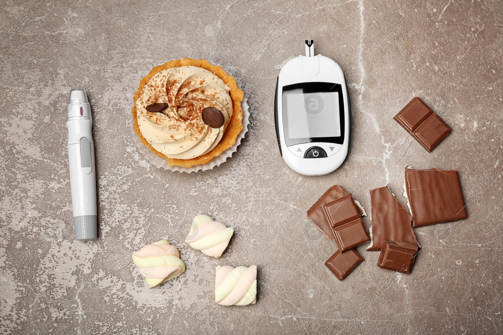 Photo of Flat lay composition with digital glucometer and sweets on color background. Diabetes concept