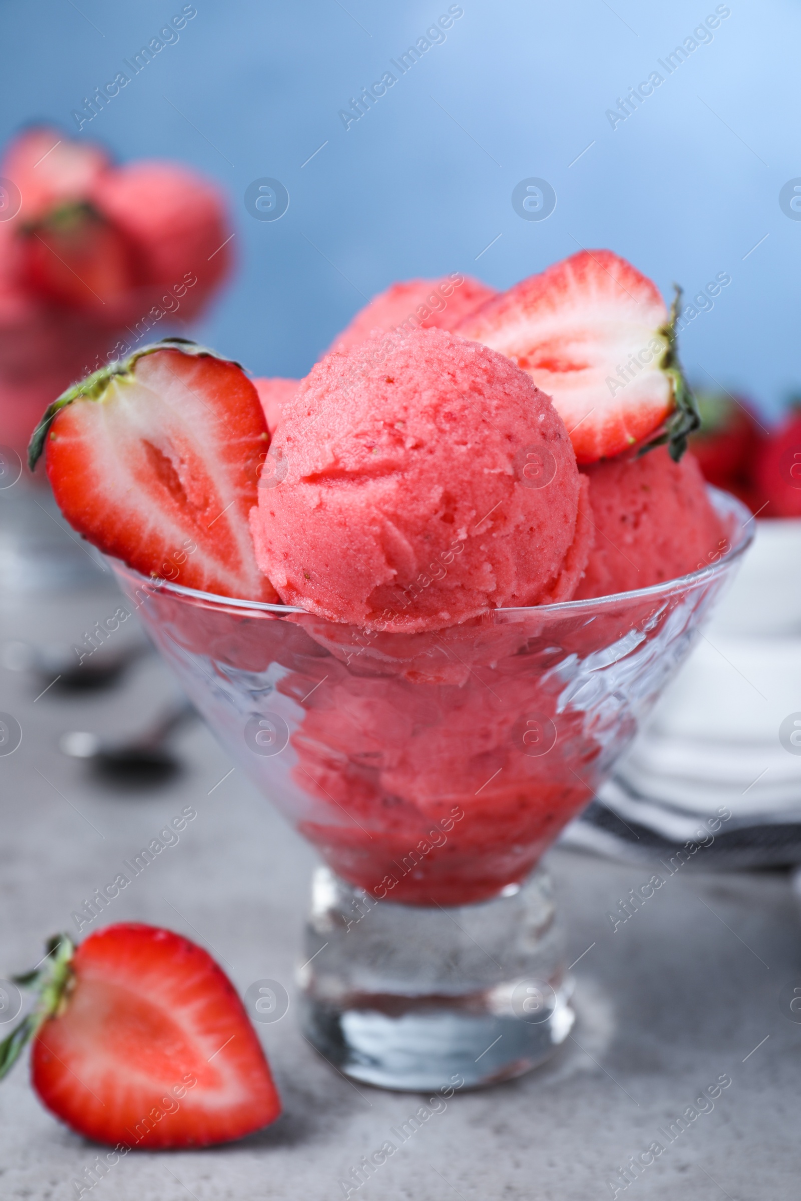 Photo of Delicious strawberry ice cream served on grey table