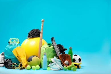 Photo of Many different sports equipment on light blue background, space for text