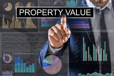 Image of Property value concept. Businessman using virtual screen
