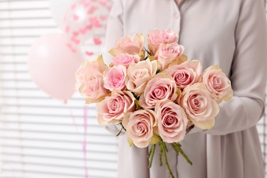 Photo of Woman holding bouquet of beautiful rose flowers indoors, closeup view and space for text. Happy birthday