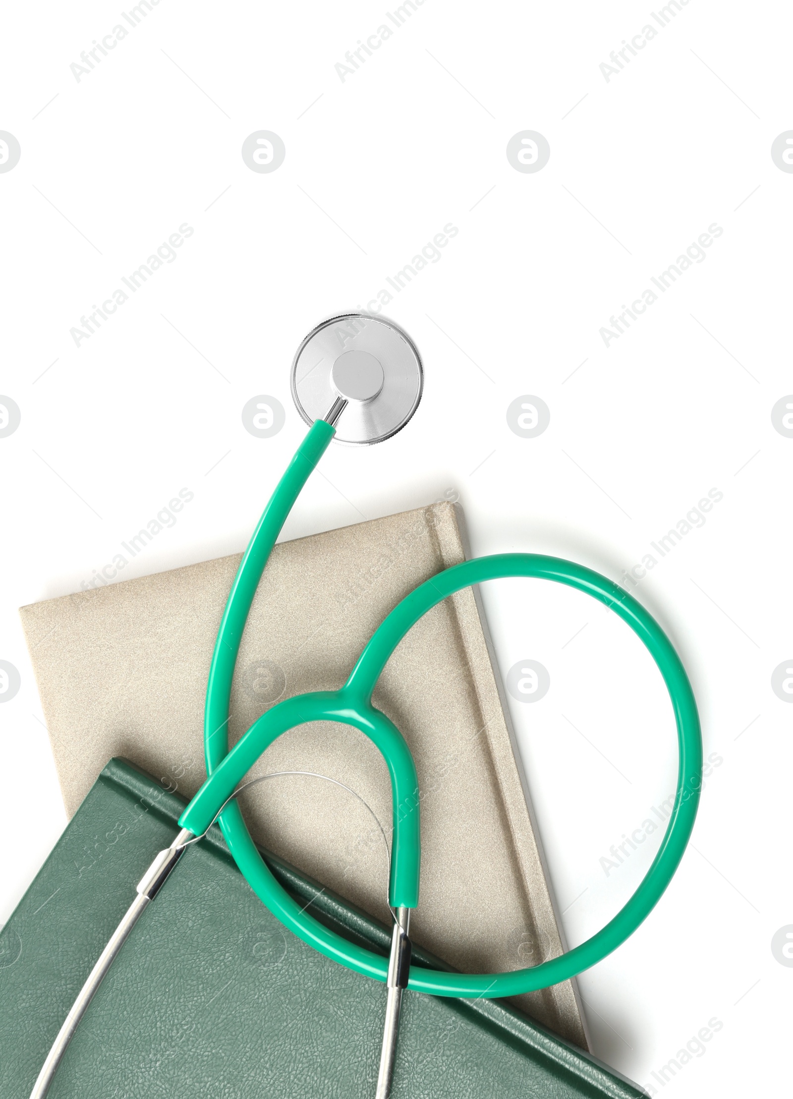 Photo of Student textbooks and stethoscope on white background, top view. Medical education