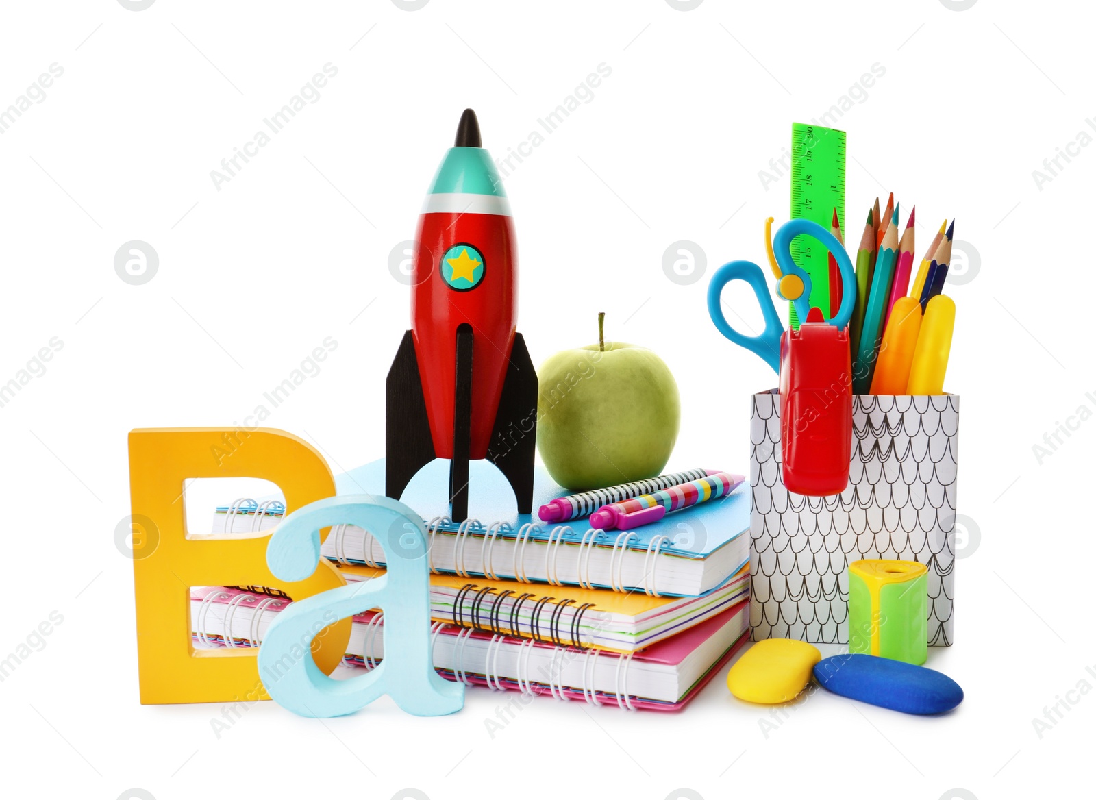 Photo of Bright toy rocket and school supplies on white background