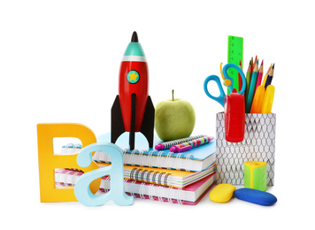 Photo of Bright toy rocket and school supplies on white background