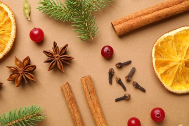 Photo of Flat lay composition with mulled wine ingredients and fir branches on brown background