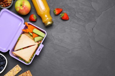 Photo of Flat lay composition with lunch box and tasty healthy food on grey table., space for text. School dinner