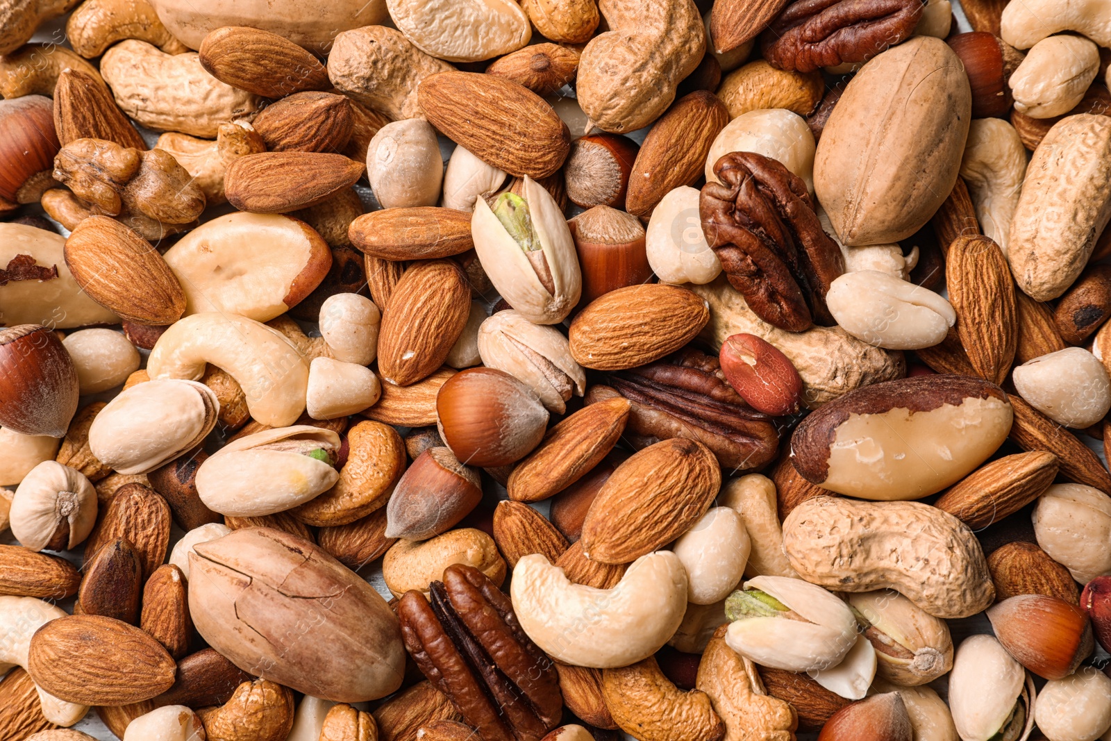 Photo of Organic mixed nuts as background, top view