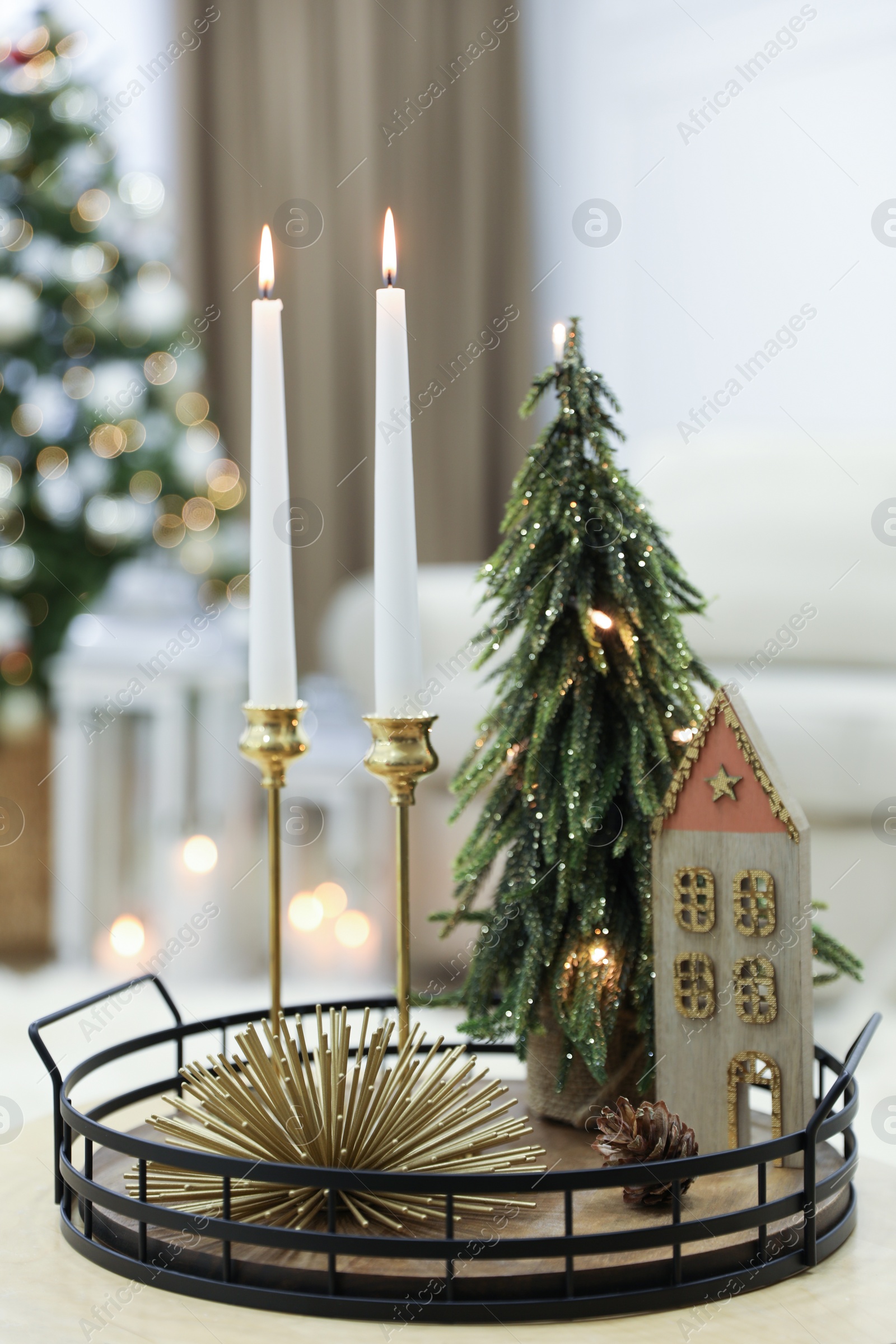 Photo of Beautiful Christmas composition with burning candles on table indoors