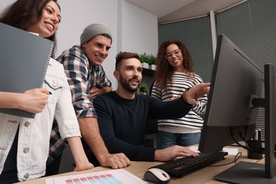 Photo of Team of employees working together in office. Startup project