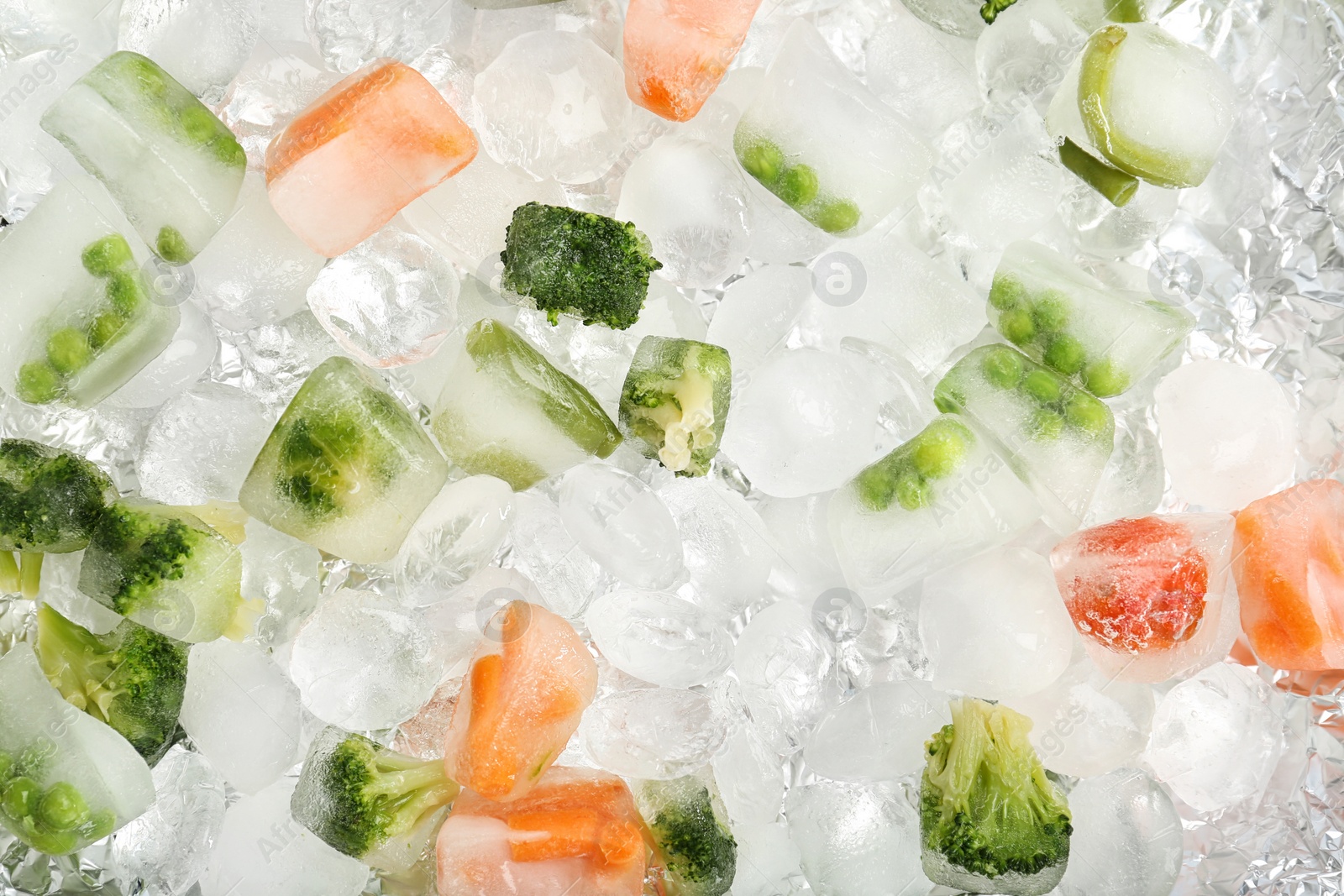 Photo of Frozen vegetables and ice cubes as background