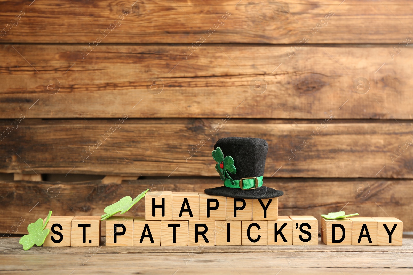 Photo of Words Happy St. Patrick's day and festive decor on wooden background. Space for text