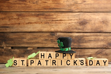 Words Happy St. Patrick's day and festive decor on wooden background. Space for text