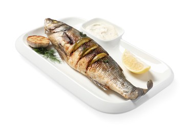 Photo of Plate with delicious baked sea bass fish, garlic, slice of lemon and sauce on white background