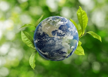 Image of Recycling concept. Earth planet with green leaves on blurred background